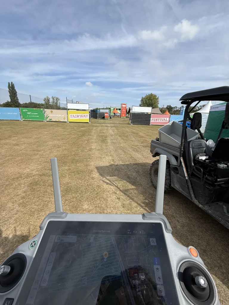 Drone controller on the Fairway Festival 2025 field during the as-built flight