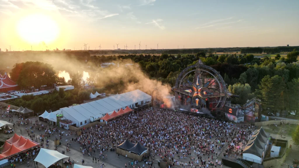 Luchtbeeld van de mainstage en het publiek op The Qontinent 2022 bij laagstaande zon