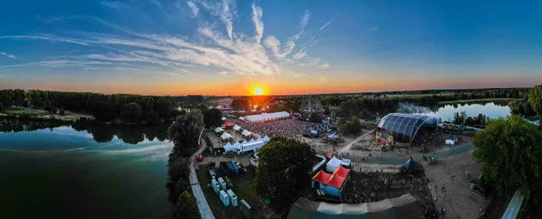 Panoramic aerial of The Qontinent 2022 at sunset by the Puyenbroeck lakes