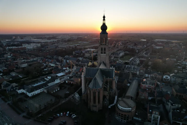 St Catherine's Church in Hoogstraten with its tower against the evening sun, drone image