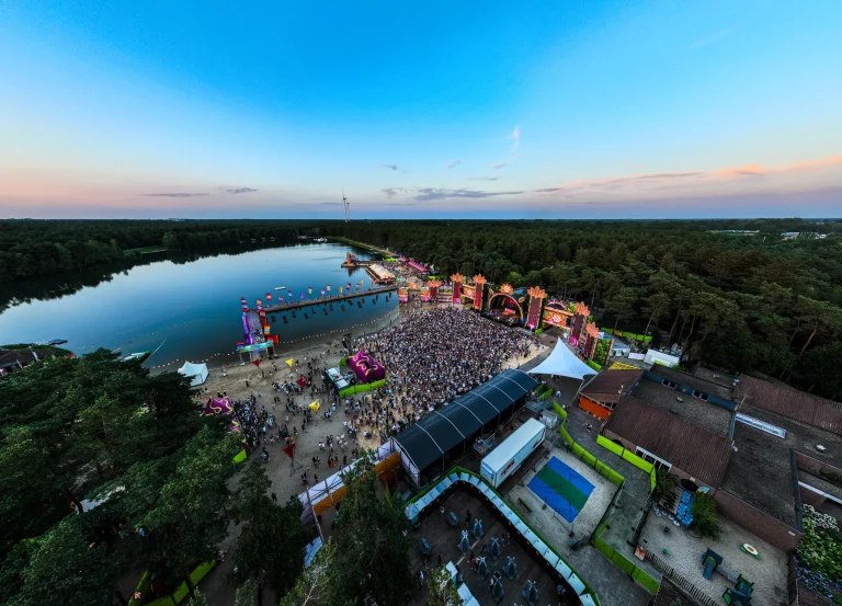 Aerial of Sunrise Festival 2024 by the De Lilse Bergen lake in evening light