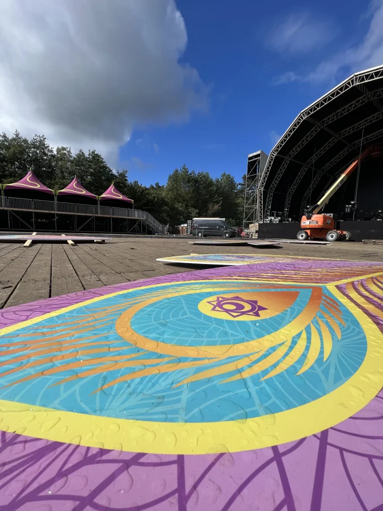 Beschilderde festivalvloer met pauwenveermotief op Sunset Festival 2022