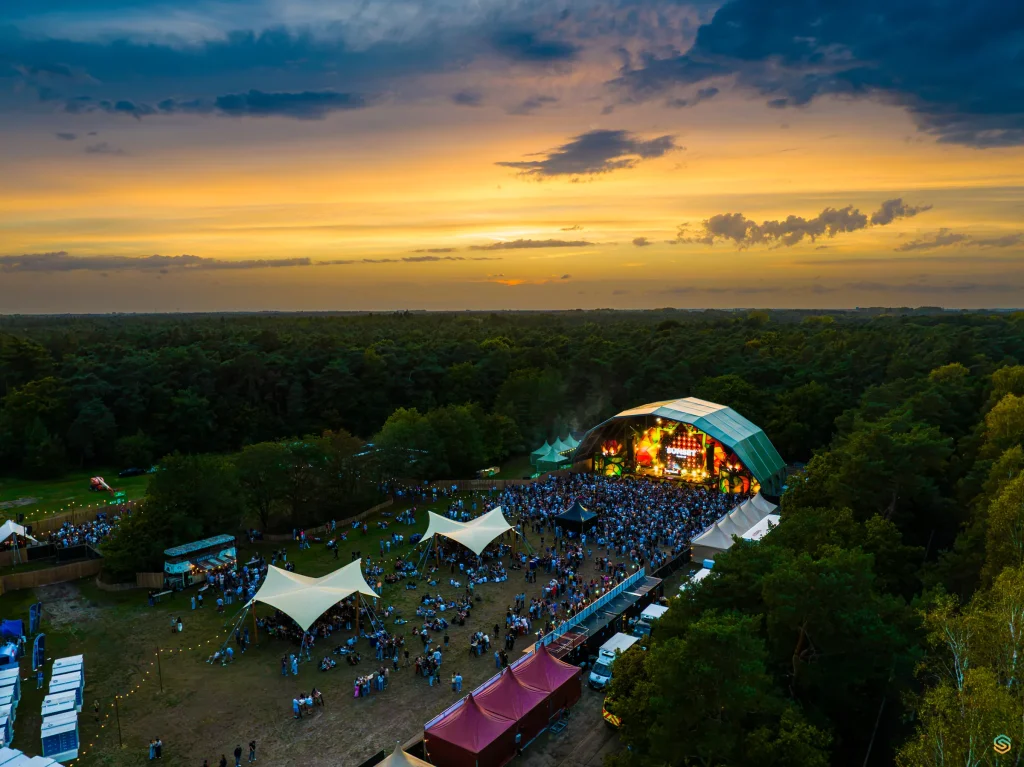 Festival field with shade sails and main stage of Sunset Festival 2025 from the air
