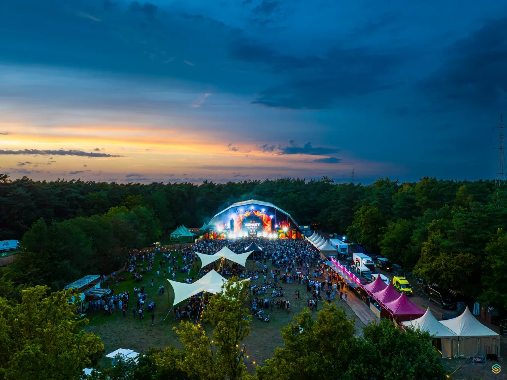 Sunset Festival 2025 at nightfall under a dark cloudy sky, aerial